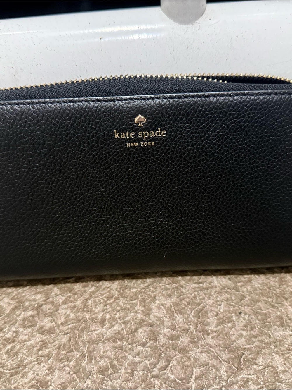 kate spade black pebbled leather zip-around wallet with gold logo